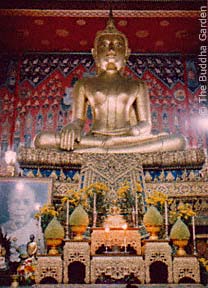 the main Buddha statue in the Viharn of a temple in Thonburi, Thailand